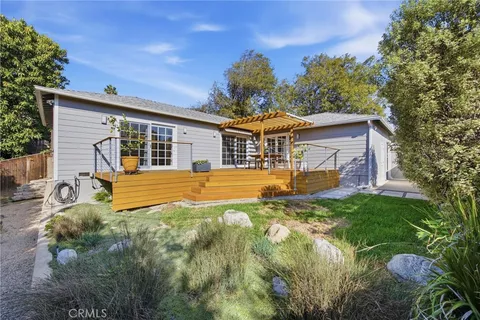 a view of a house with pool and sitting area