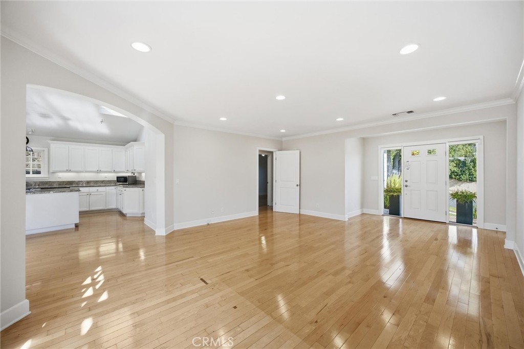 3513 May Street Los Angeles, CA 90066 - Photo 3 of 34 a view of an empty room with wooden floor and a kitchen
