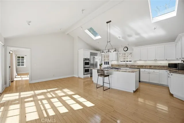 a kitchen with cabinets and wooden floor