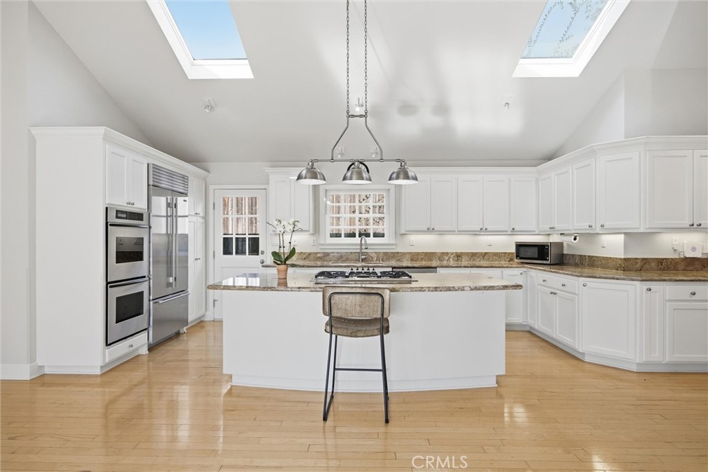 3513 May Street Los Angeles, CA 90066 - Photo 6 of 34 a kitchen with stainless steel appliances granite countertop a stove top oven a sink a dining table and chairs