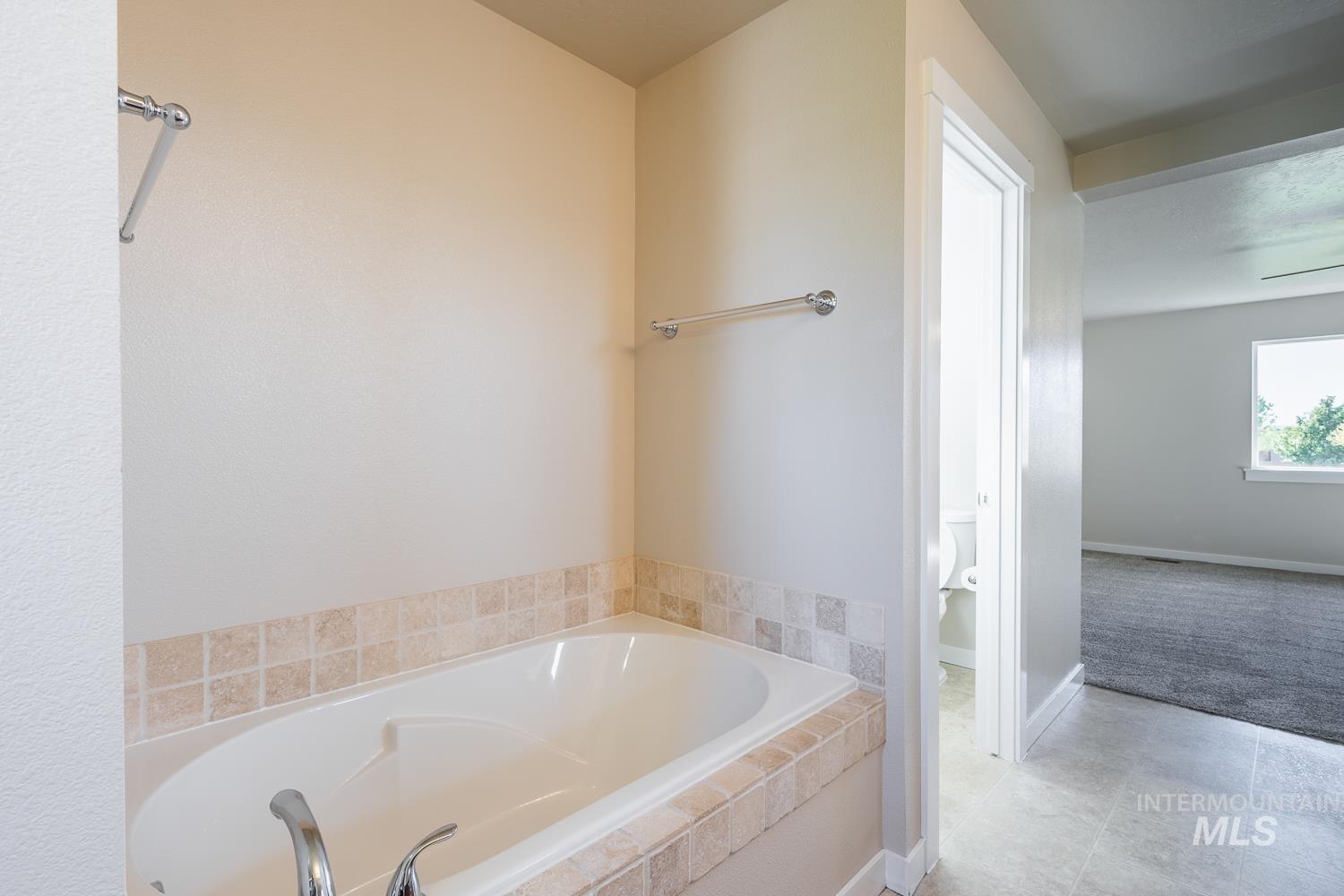 14253 Moreno Drive Caldwell, ID 83607 - Photo 21 of 48 Built-in soaking tub with a tiled surround, chrome fixtures, and a neutral wall finish
