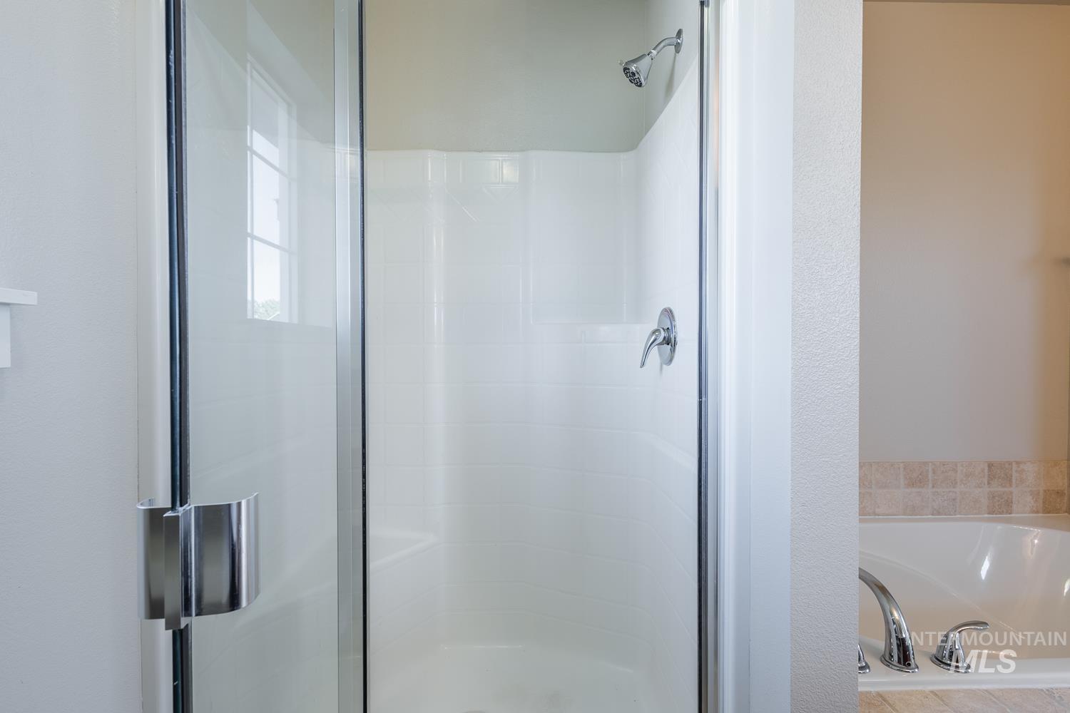 14253 Moreno Drive Caldwell, ID 83607 - Photo 22 of 48 Glass-enclosed shower with a chrome shower head and faucet