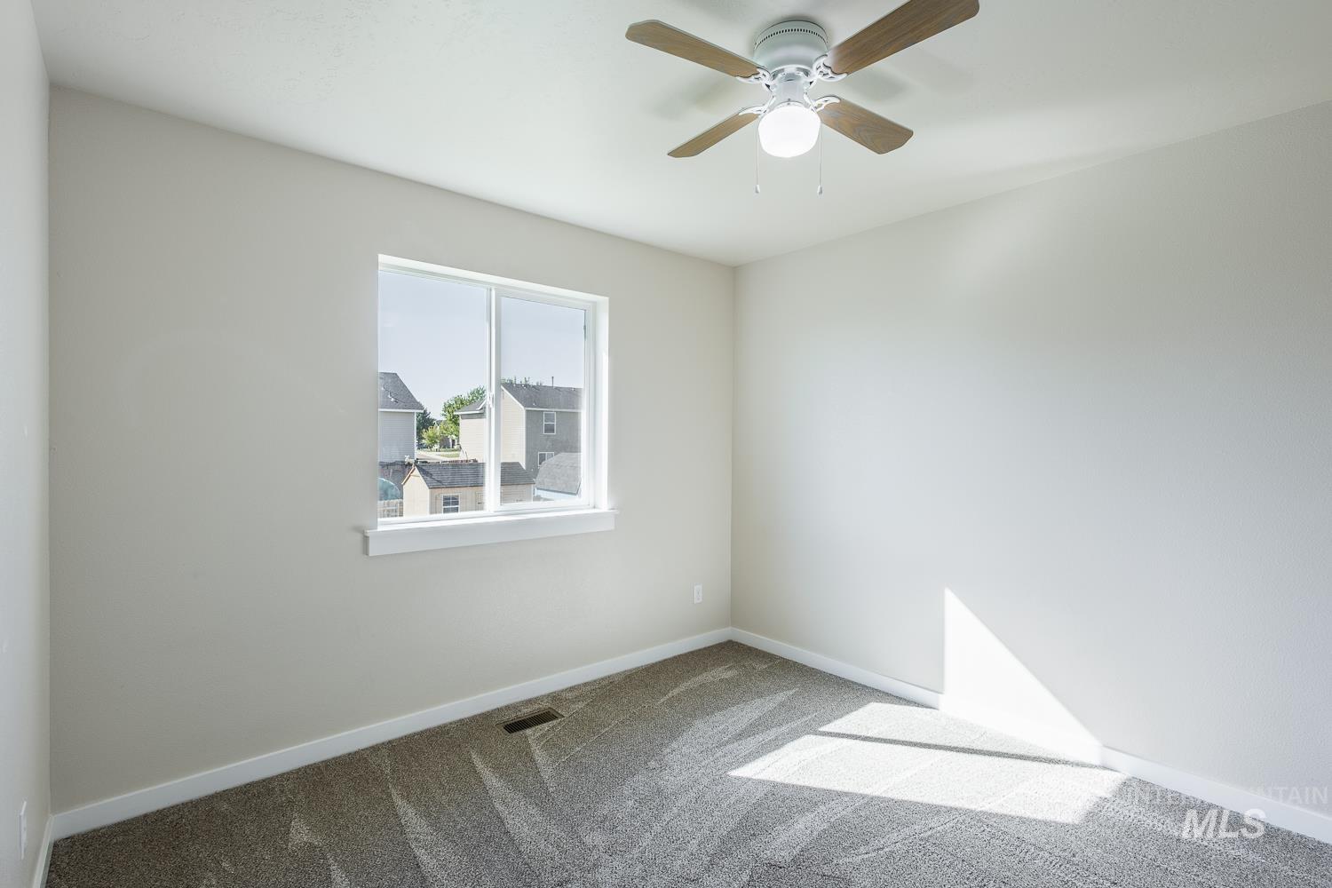 14253 Moreno Drive Caldwell, ID 83607 - Photo 25 of 48 Room featuring neutral wall tones, gray patterned carpeting, and white baseboards