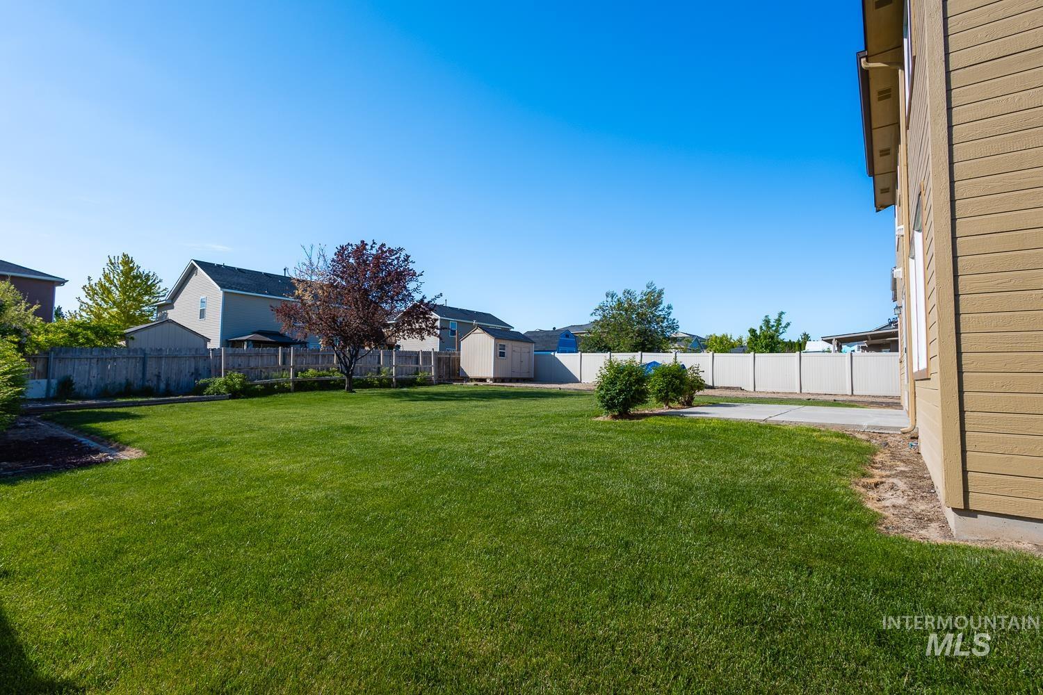 14253 Moreno Drive Caldwell, ID 83607 - Photo 35 of 48 Expansive green lawn with a mature deciduous tree and established shrubs