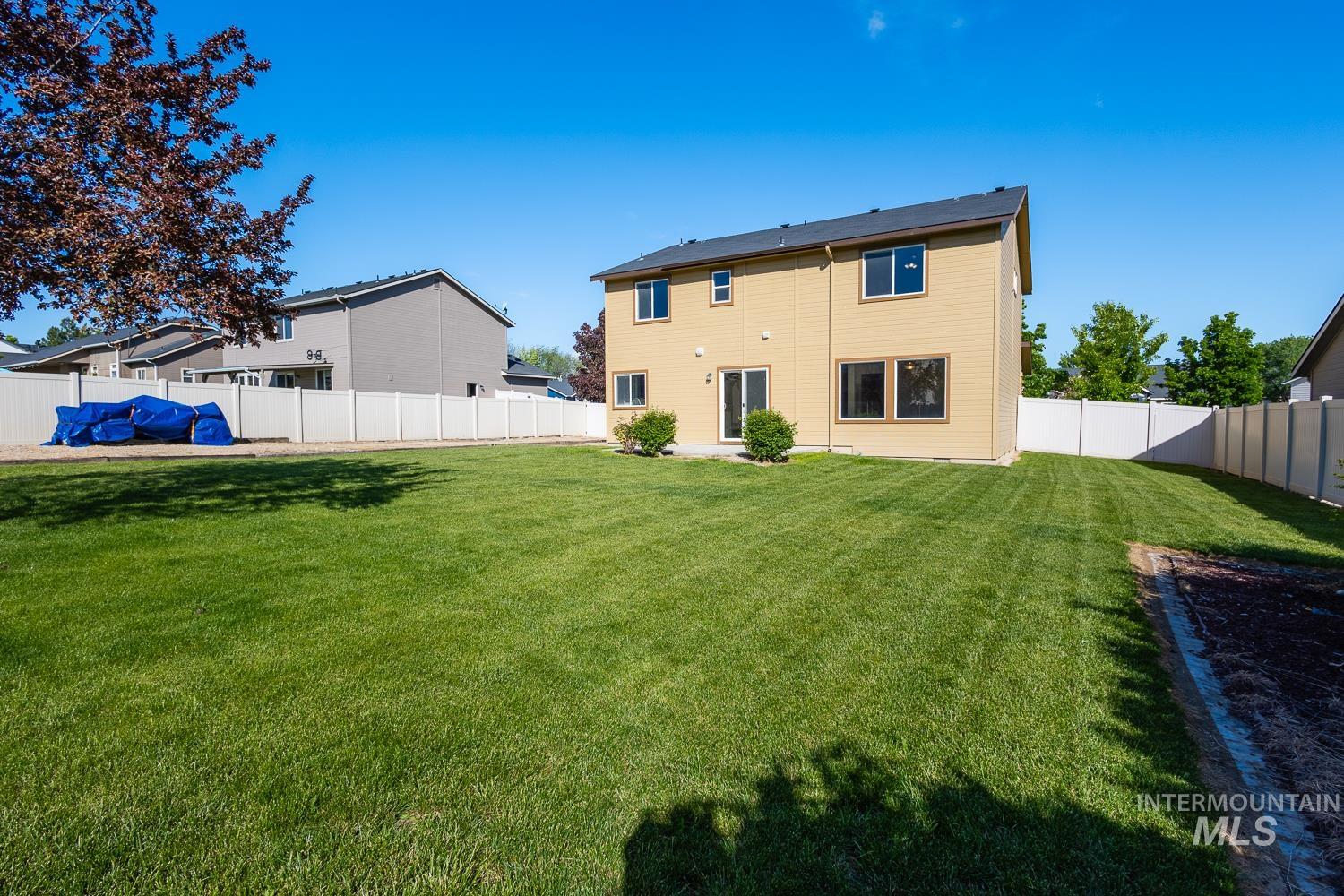 14253 Moreno Drive Caldwell, ID 83607 - Photo 36 of 48 Expansive backyard featuring a manicured lawn, a concrete patio, and a vinyl privacy fence