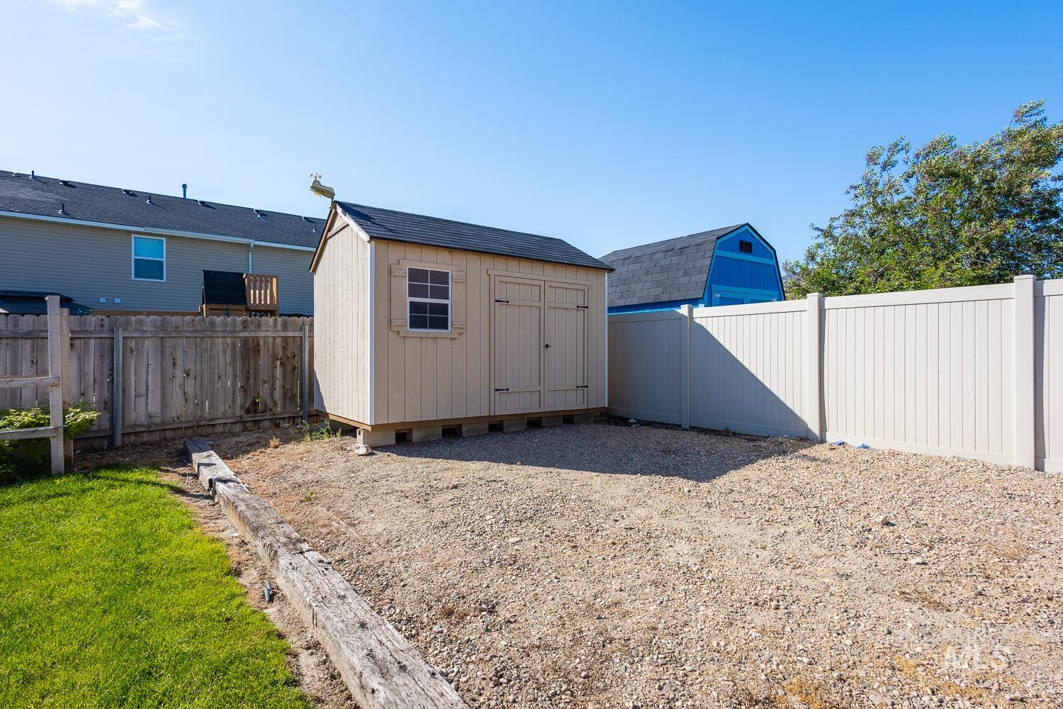 14253 Moreno Drive Caldwell, ID 83607 - Photo 39 of 48 Spacious gravel area featuring a light-colored storage shed with a shingle roof and a single window