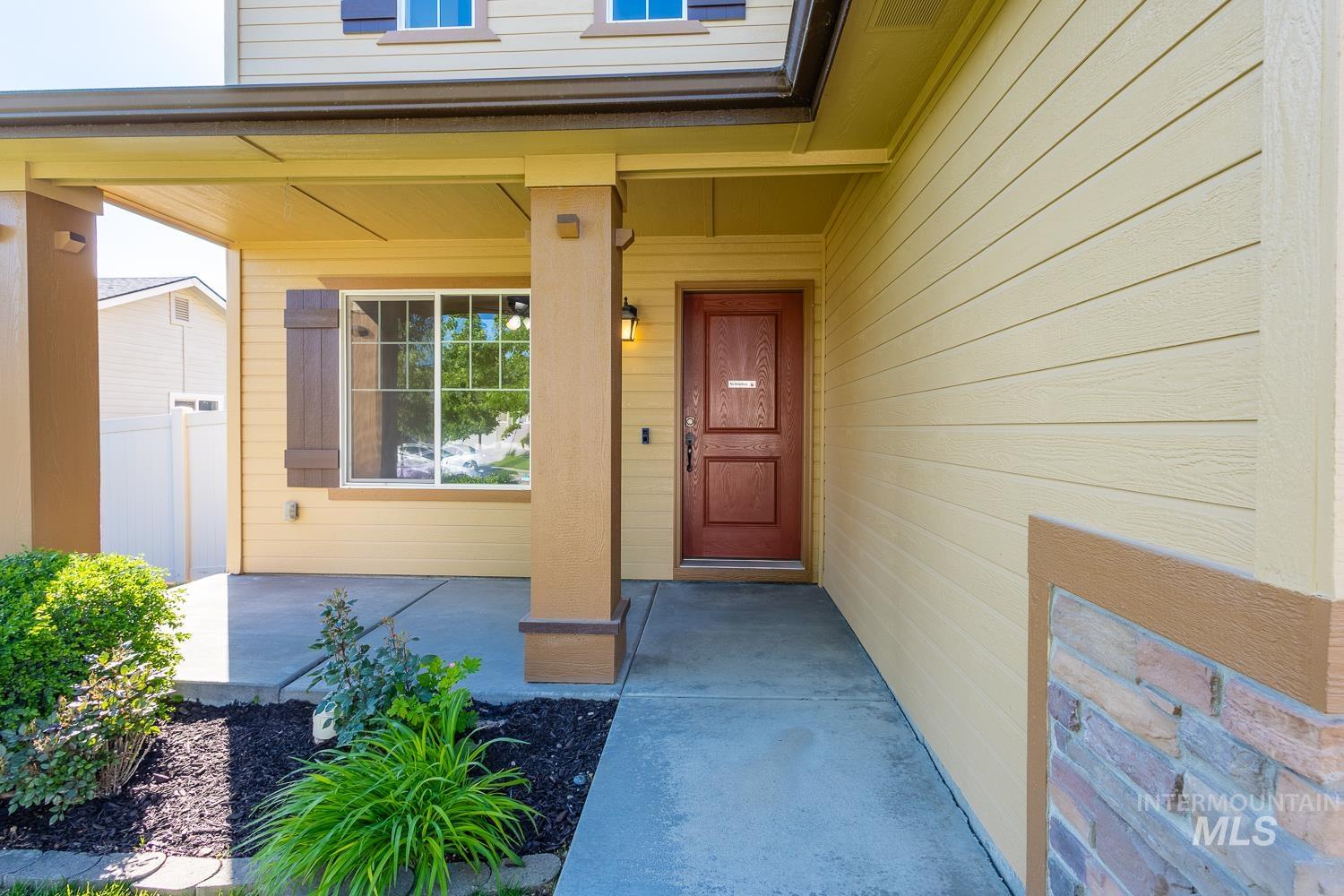 14253 Moreno Drive Caldwell, ID 83607 - Photo 4 of 48 Inviting covered front porch with a rich wood-tone entry door and durable siding