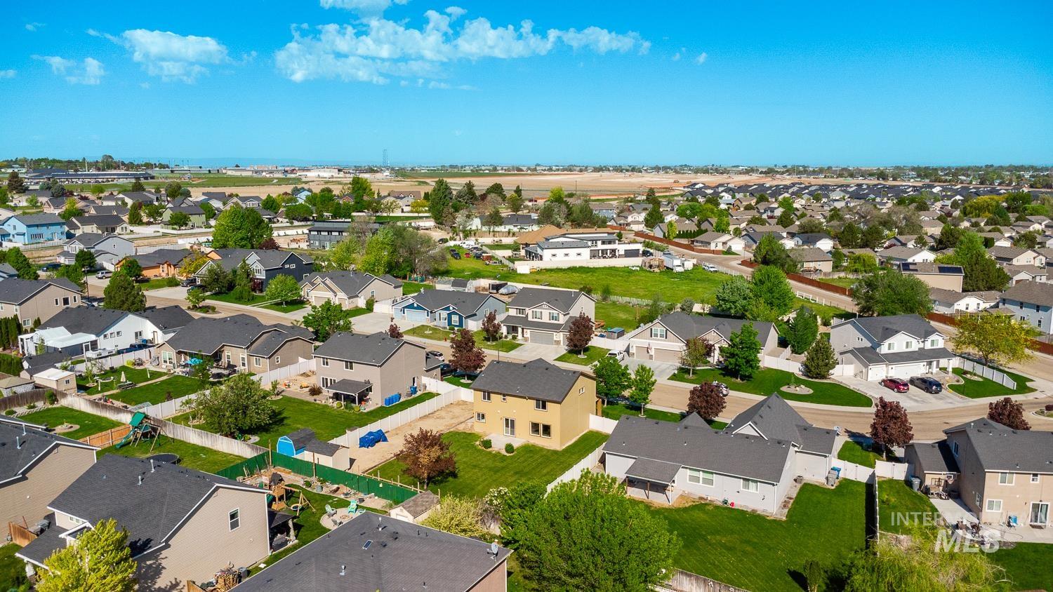 14253 Moreno Drive Caldwell, ID 83607 - Photo 45 of 48 Aerial perspective showcasing a residential neighborhood with diverse housing styles, expansive green spaces, and mature landscaping