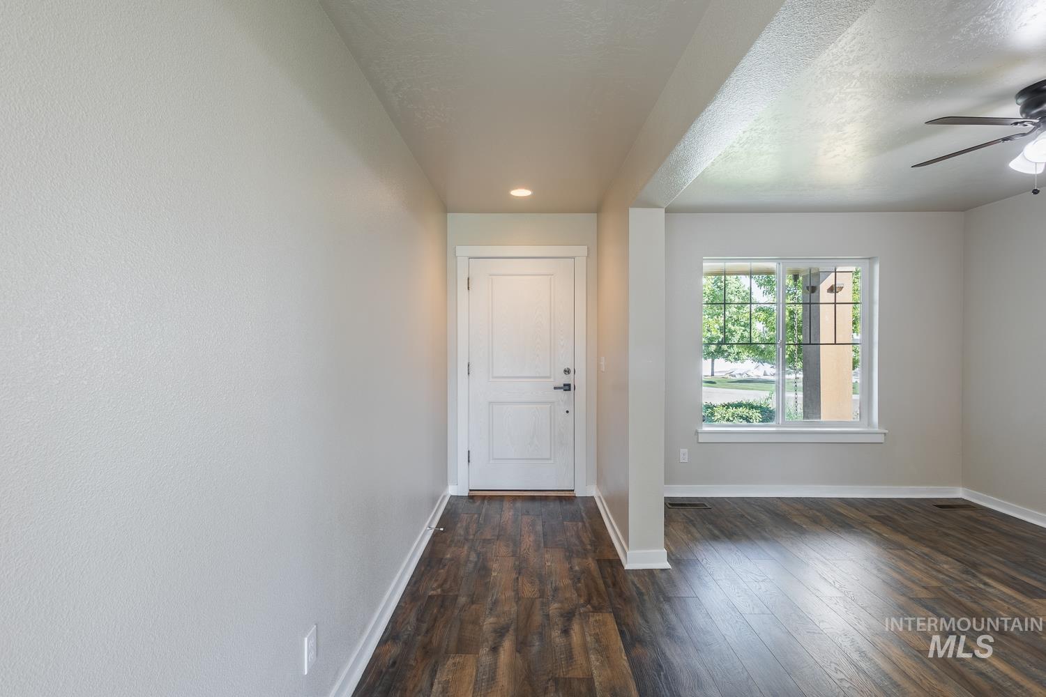 14253 Moreno Drive Caldwell, ID 83607 - Photo 5 of 48 Entryway featuring wood-finish flooring, a paneled entry door with dark hardware, and recessed lighting