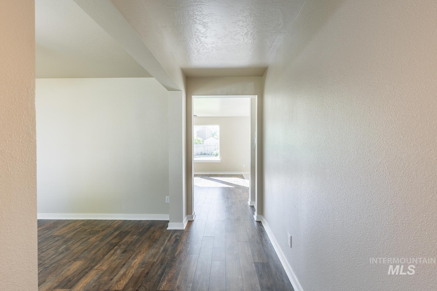 14253 Moreno Drive Caldwell, ID 83607 - Photo 8 of 48 Interior featuring wood-finish flooring, light-toned wall finishes, and white baseboards