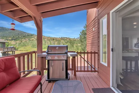 a view of a balcony with wooden floor and outdoor seating