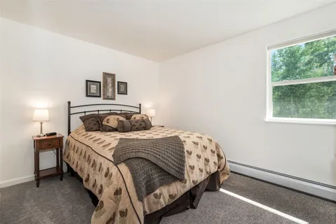 a bedroom with a bed and a night stand