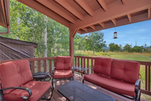 a roof deck with a table and chairs