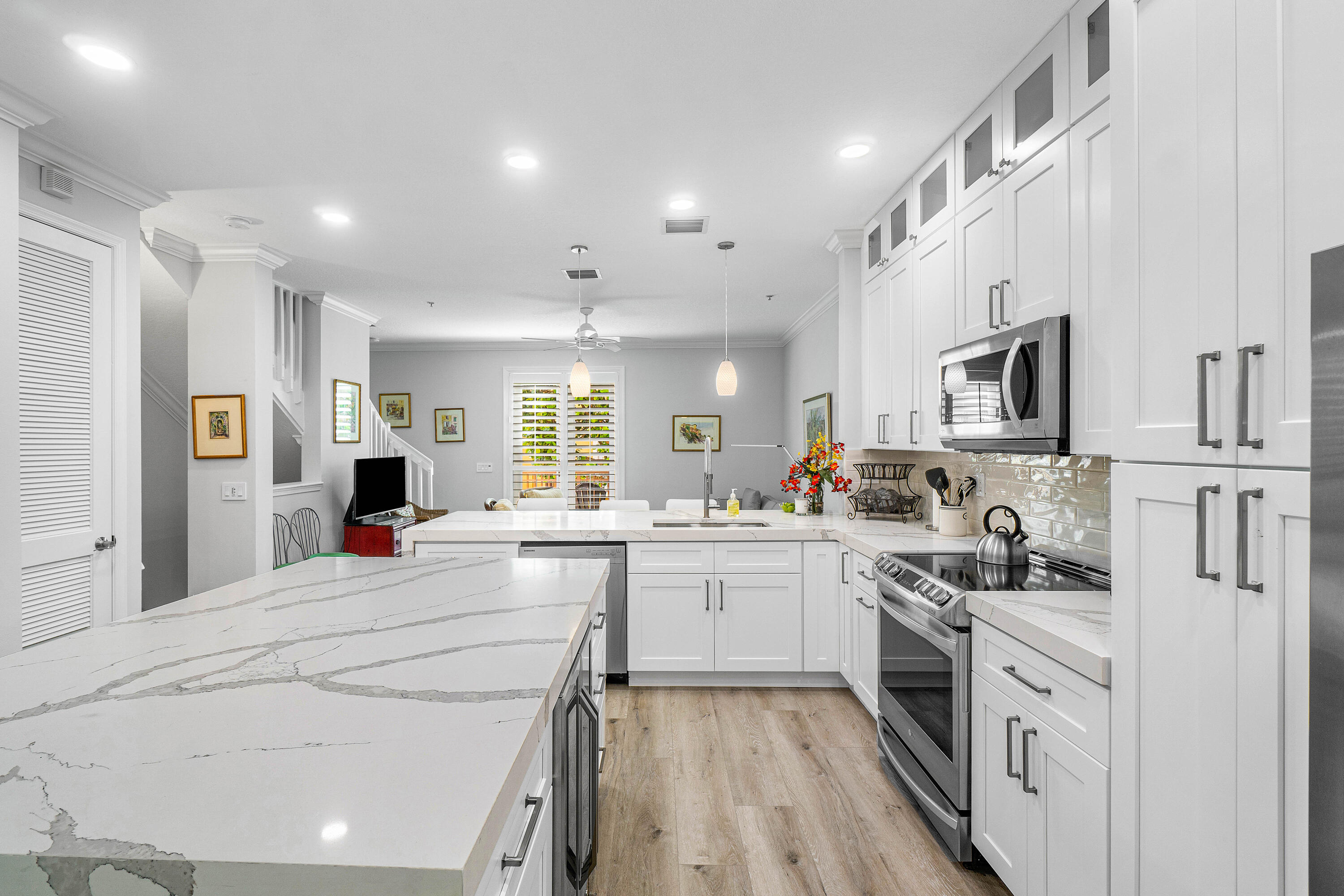 65 Southeast 5th Avenue, Unit B Delray Beach, FL 33483 - Photo 1 of 47 a kitchen with stainless steel appliances kitchen island granite countertop a stove and white cabinets