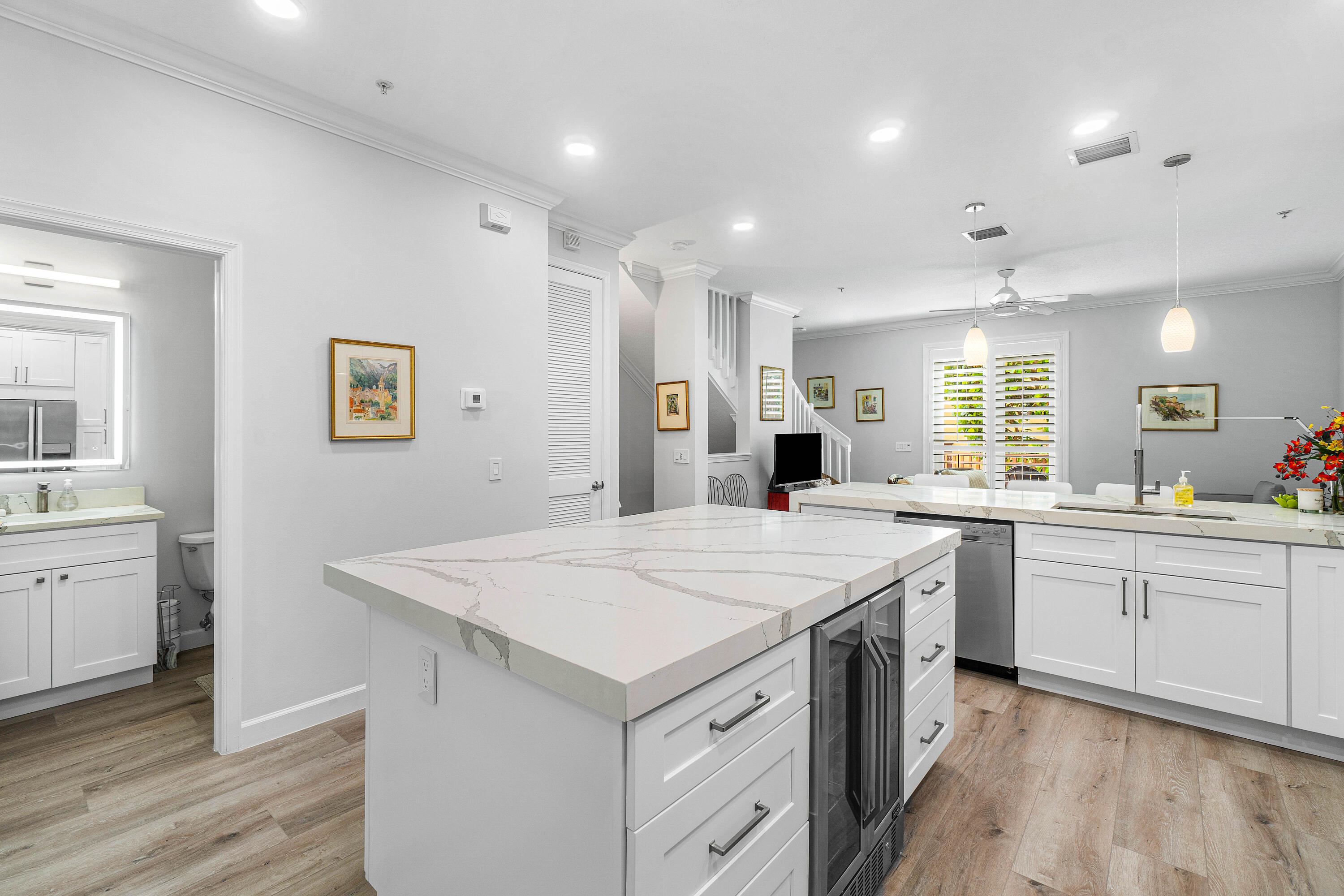 65 Southeast 5th Avenue, Unit B Delray Beach, FL 33483 - Photo 13 of 47 a kitchen with a sink a stove a refrigerator and white cabinets