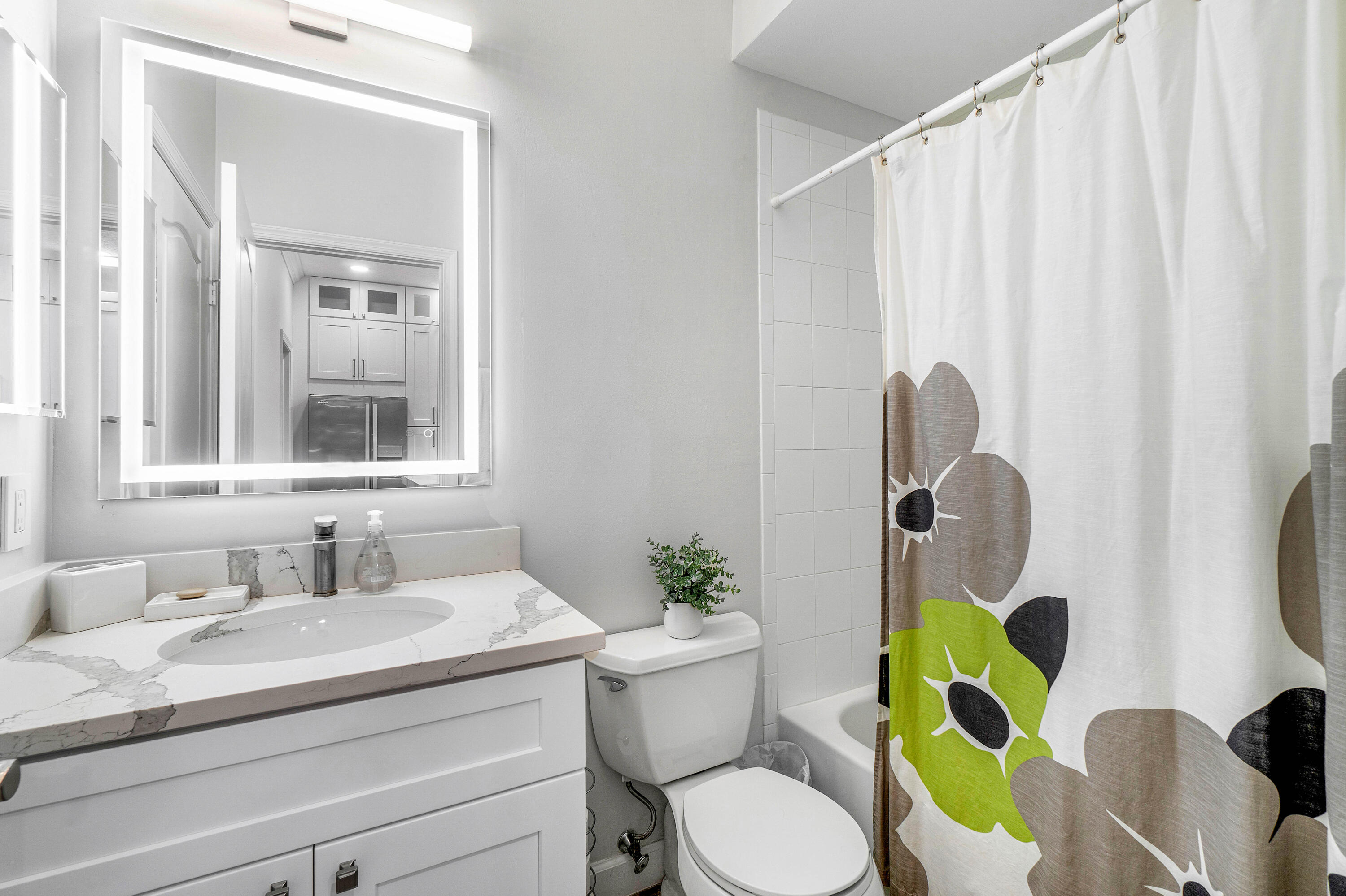 65 Southeast 5th Avenue, Unit B Delray Beach, FL 33483 - Photo 20 of 47 a bathroom with a granite countertop toilet sink and mirror