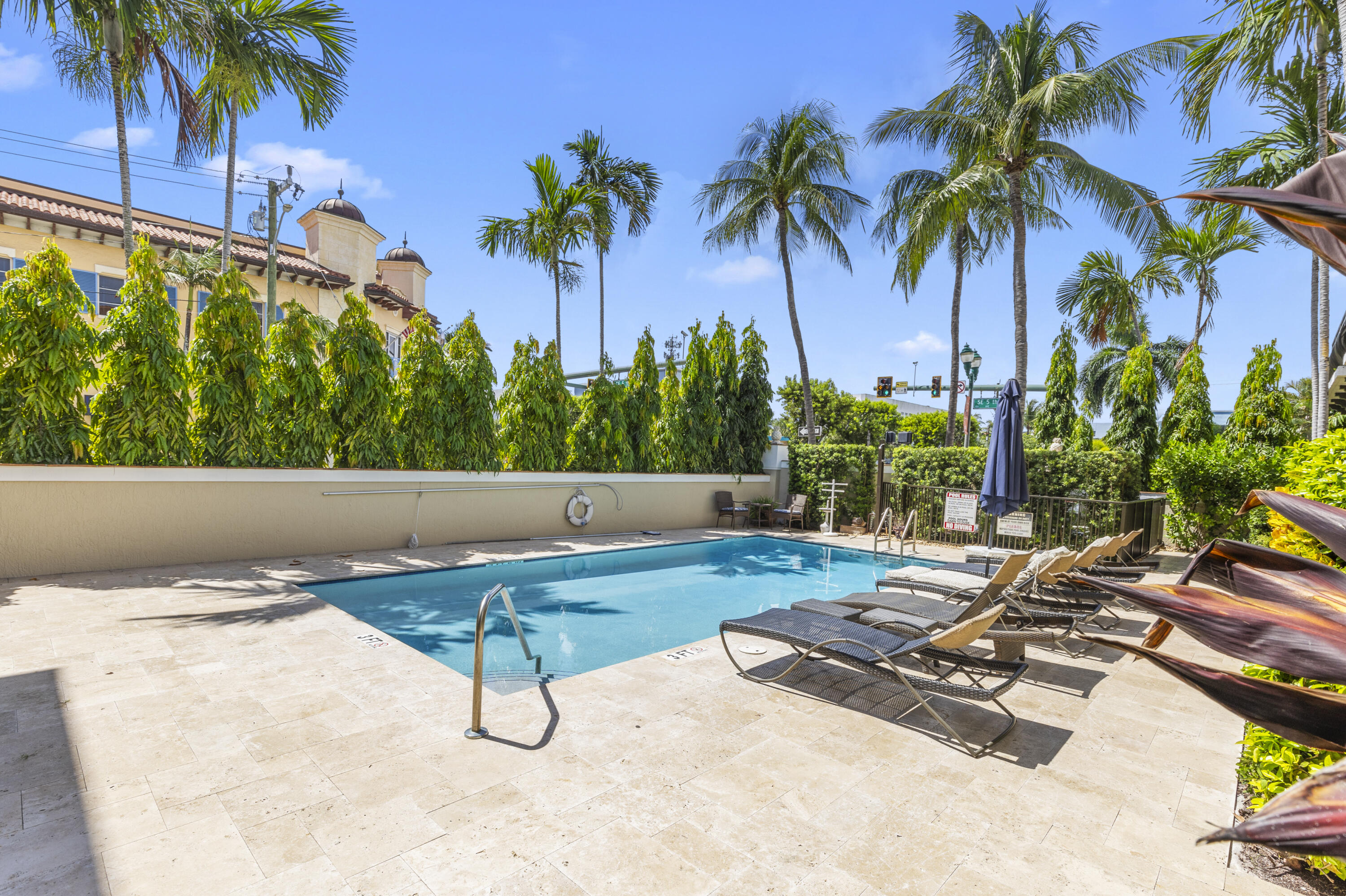 65 Southeast 5th Avenue, Unit B Delray Beach, FL 33483 - Photo 3 of 47 a backyard of a house with palm trees