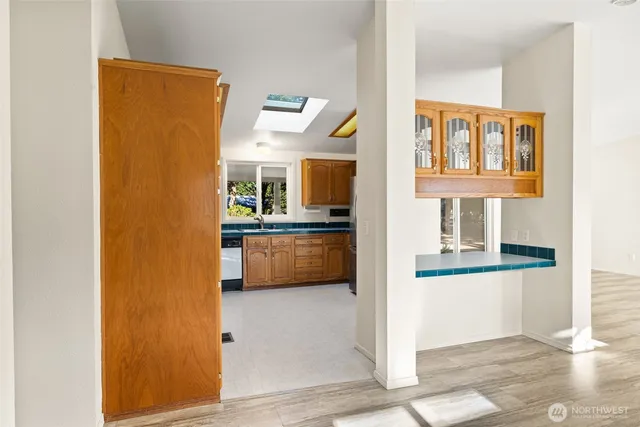 a view of a kitchen with a sink and cabinets