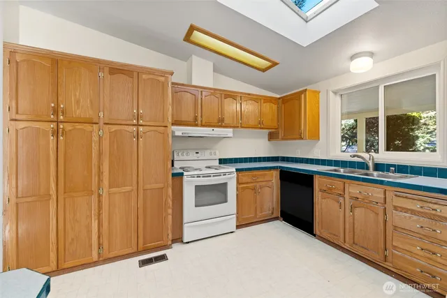 a kitchen with granite countertop cabinets stainless steel appliances and a sink