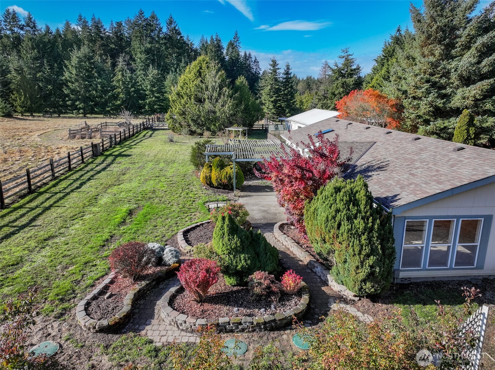 132 Cosmos Lane Port Angeles, WA 98362 - Photo 2 of 40 a view of a backyard with chair and flowers