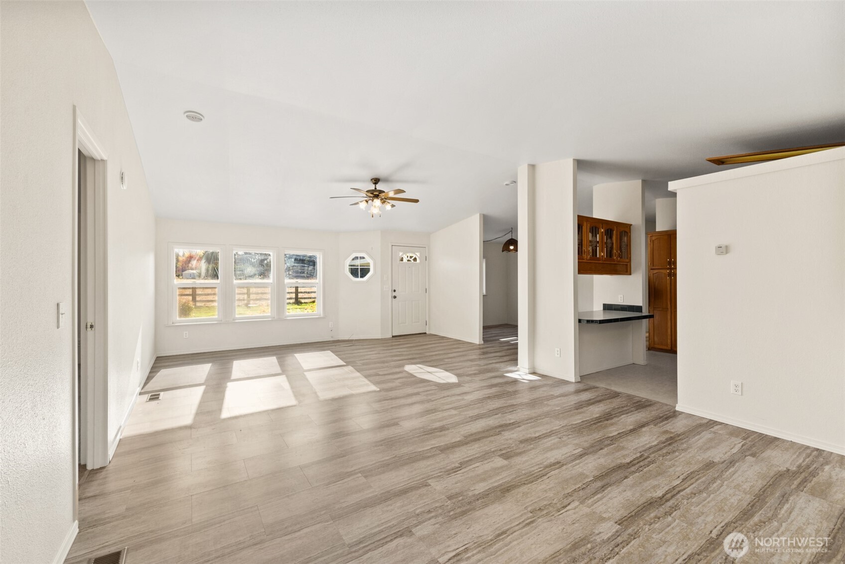 132 Cosmos Lane Port Angeles, WA 98362 - Photo 10 of 40 a view of an empty room with wooden floor and a window