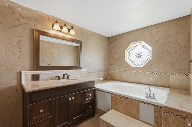 2875 North Hill Field Road, Unit 111 Layton, UT 84041 - Photo 14 of 30 Full bathroom featuring vanity and a garden tub