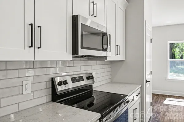 a kitchen with appliances a sink and cabinets
