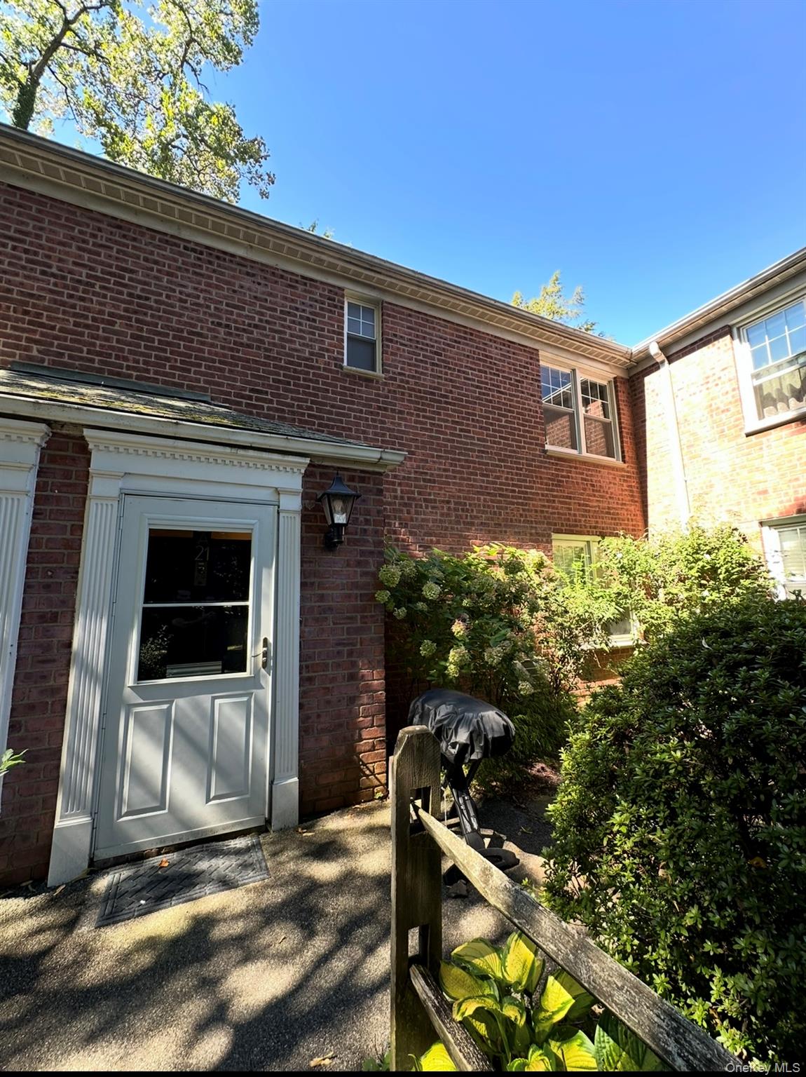 100 Cedar Street, Unit A21 Dobbs Ferry, NY 10522 - Photo 1 of 12 Entrance to property with brick siding and a patio area