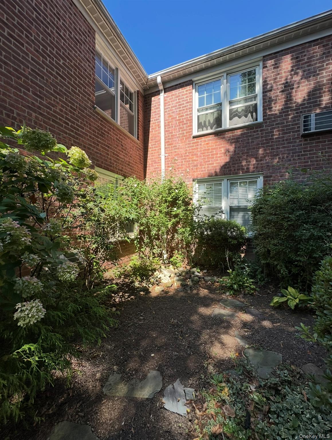 100 Cedar Street, Unit A21 Dobbs Ferry, NY 10522 - Photo 3 of 12 View of property exterior featuring brick siding