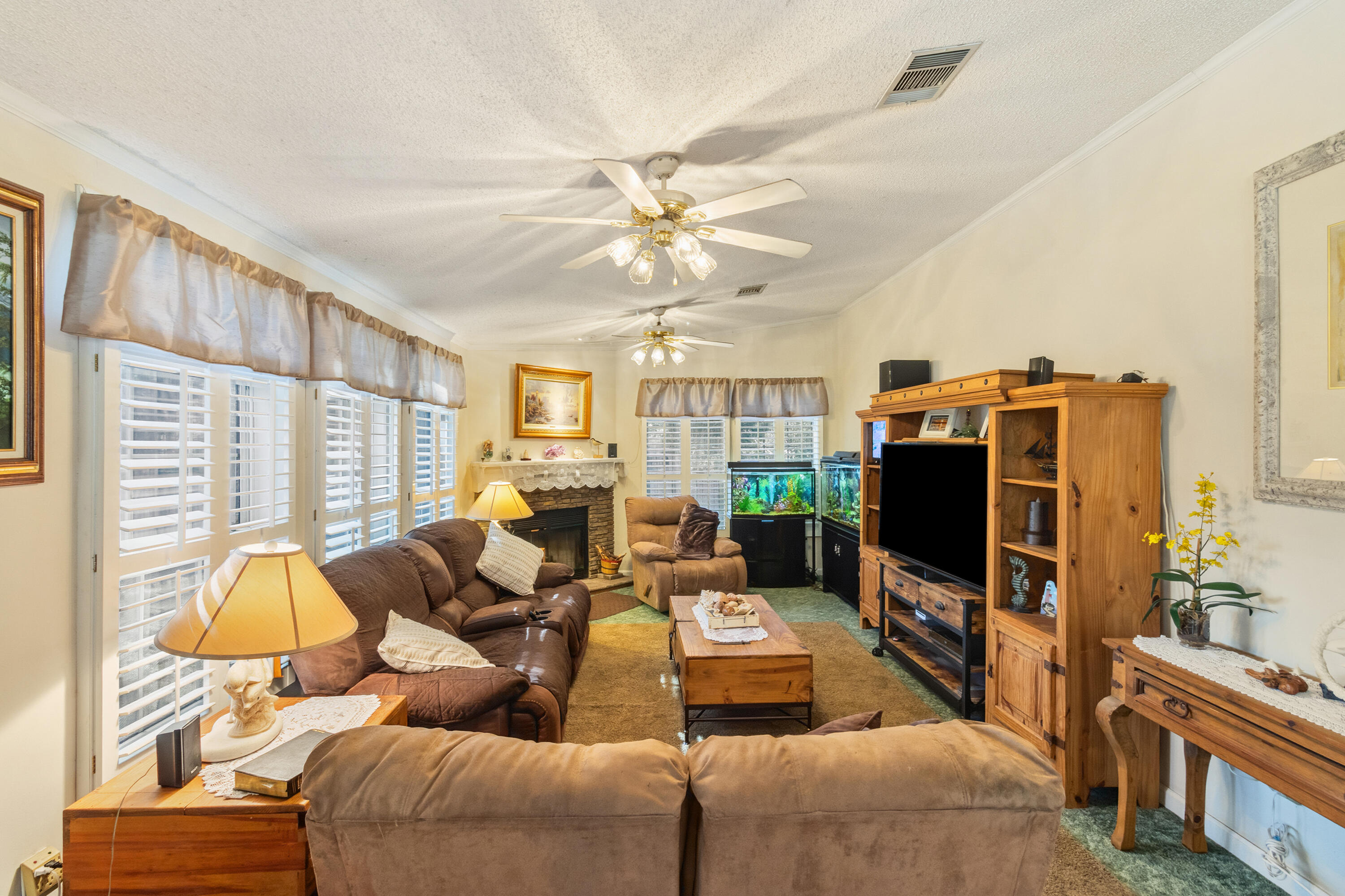 387 Pope Street Freeport, FL 32439 - Photo 13 of 82 a living room with furniture a flat screen tv and a window