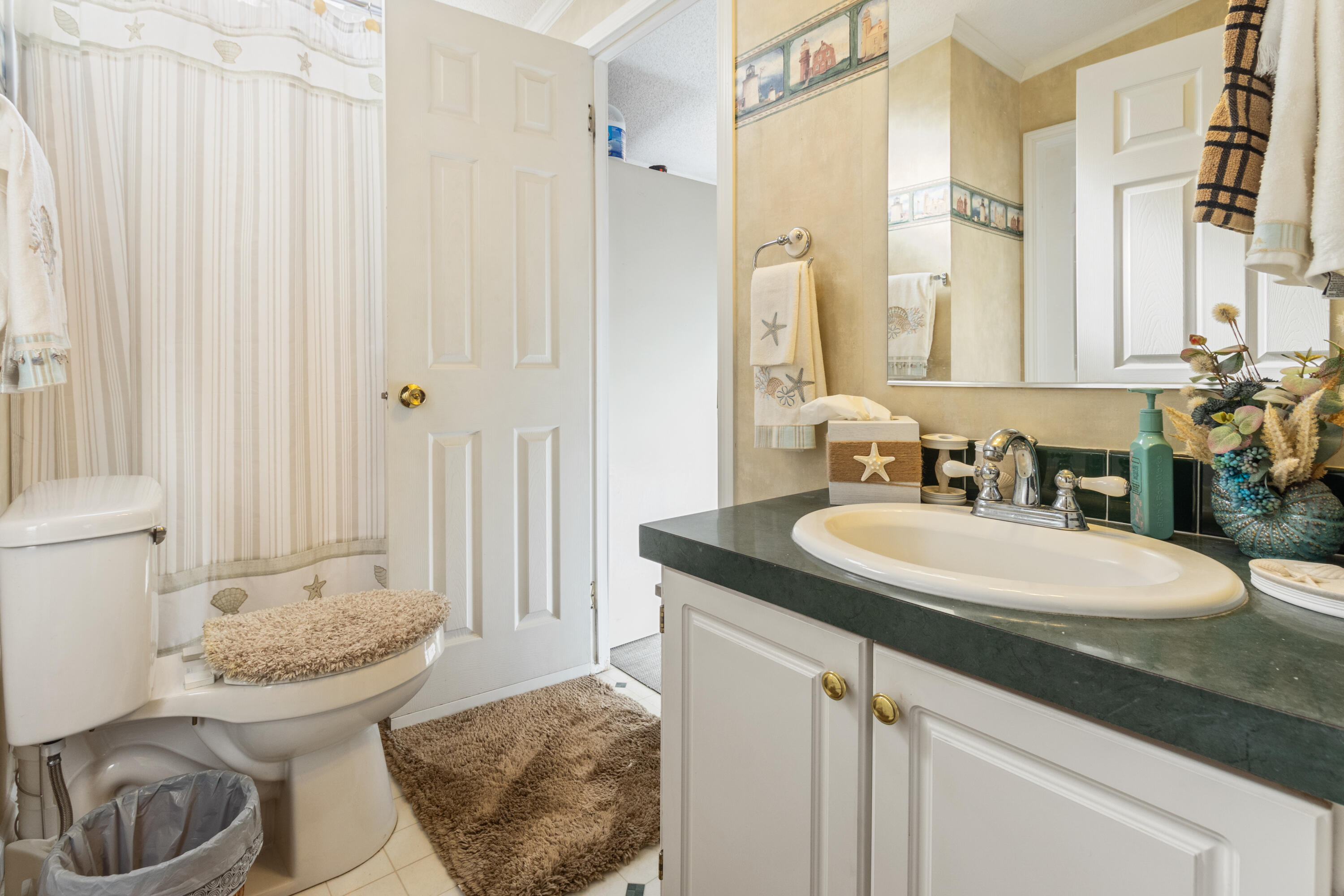 387 Pope Street Freeport, FL 32439 - Photo 29 of 82 a bathroom with a granite countertop sink and a mirror