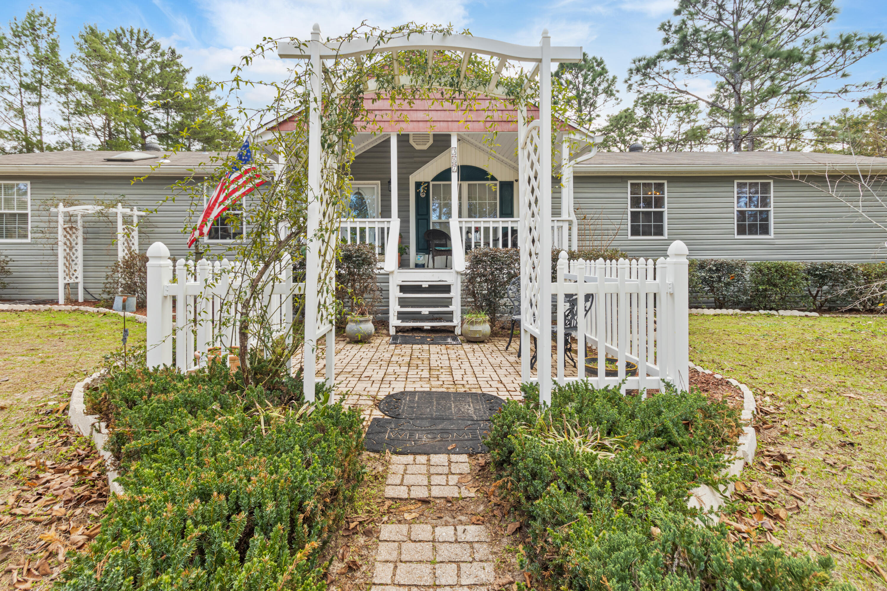 387 Pope Street Freeport, FL 32439 - Photo 42 of 82 a front view of a house with a yard