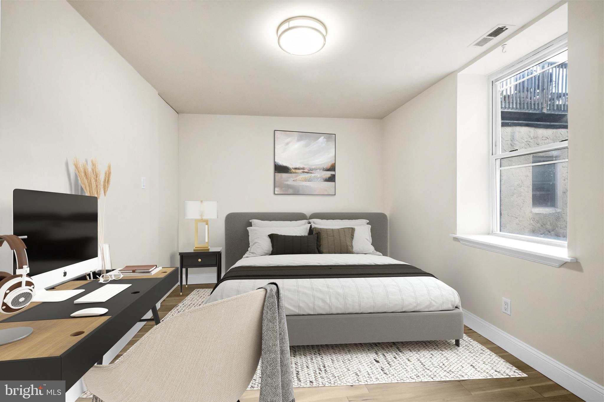 234 Bainbridge Street, Unit 2F Philadelphia, PA 19147 - Photo 6 of 10 a bedroom with a bed and a flat screen tv