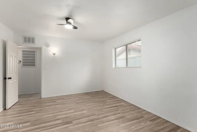 wooden floor in an empty room with a window