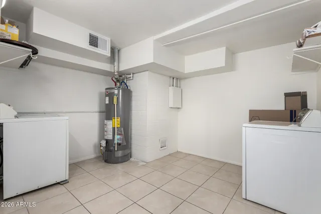 a view of storage and utility room with closet