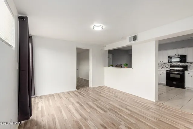 a view of a kitchen with wooden floor and a sink