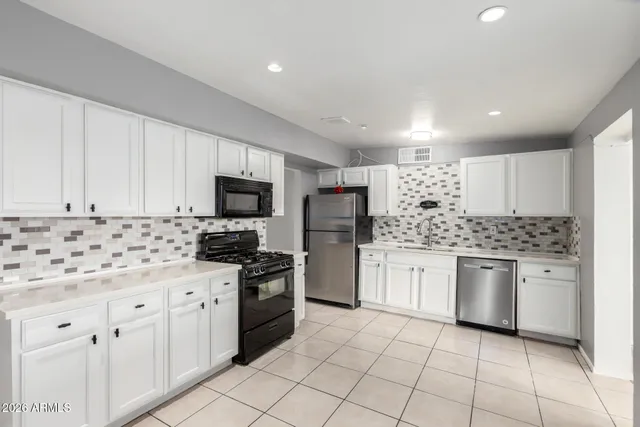 a kitchen with granite countertop cabinets and stainless steel appliances