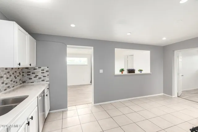 a kitchen with granite countertop a sink and a stove top oven