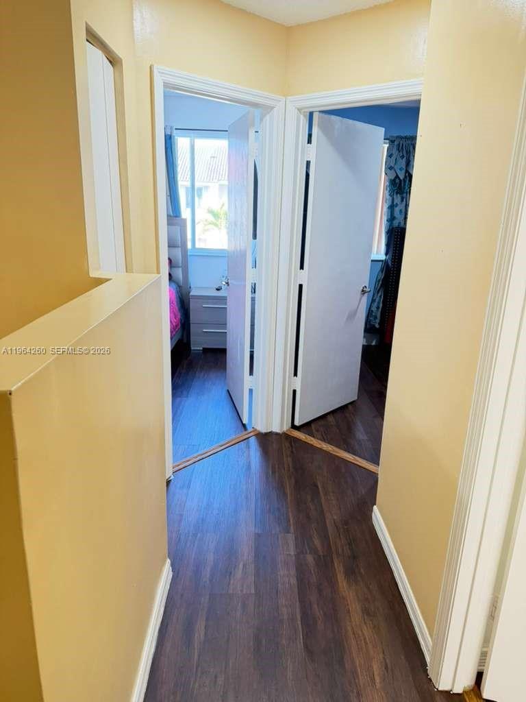 14012 Southwest 179th Street Miami, FL 33177 - Photo 13 of 17 a view of a hallway with wooden floor and stairs