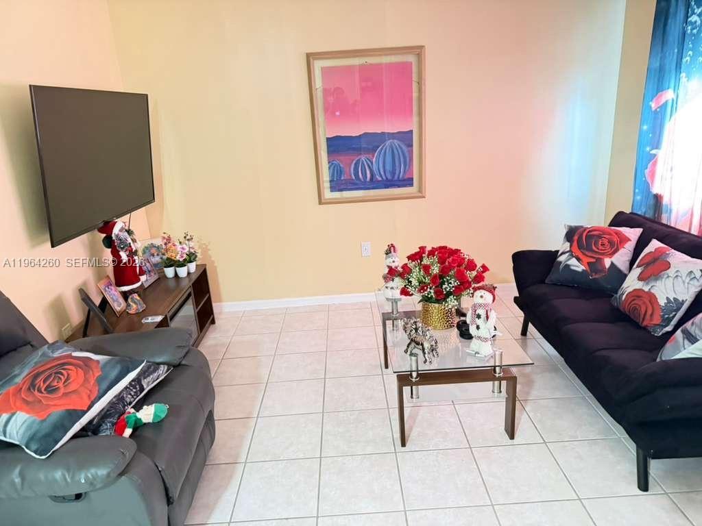 14012 Southwest 179th Street Miami, FL 33177 - Photo 2 of 17 a living room with furniture and a flat screen tv