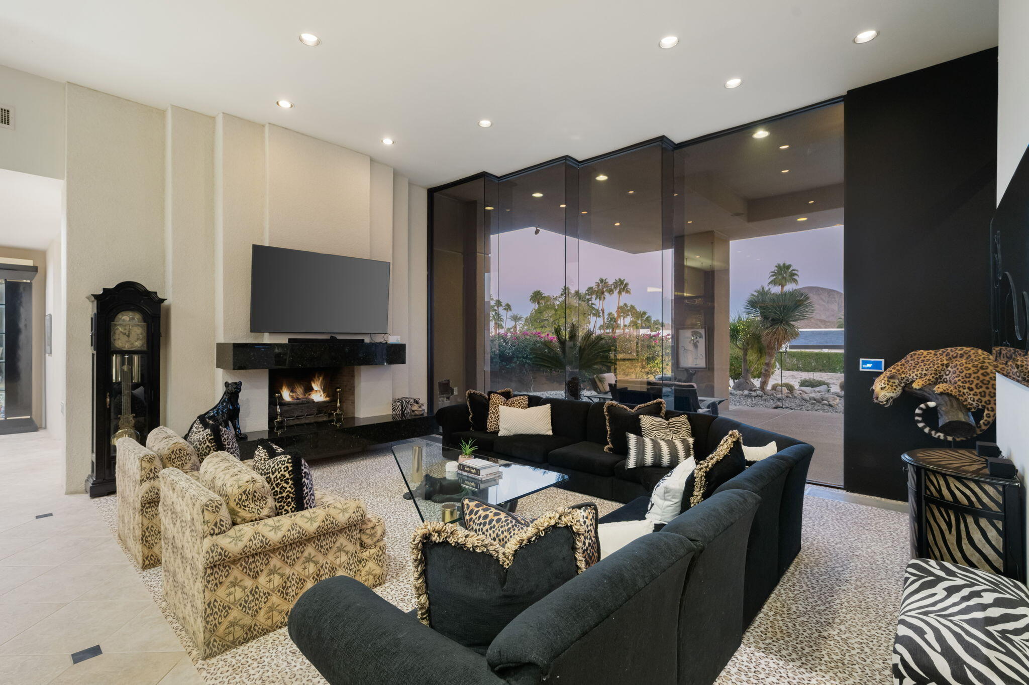 73380 Agave Lane Palm Desert, CA 92260 - Photo 11 of 81 a living room with furniture a flat screen tv and a fireplace