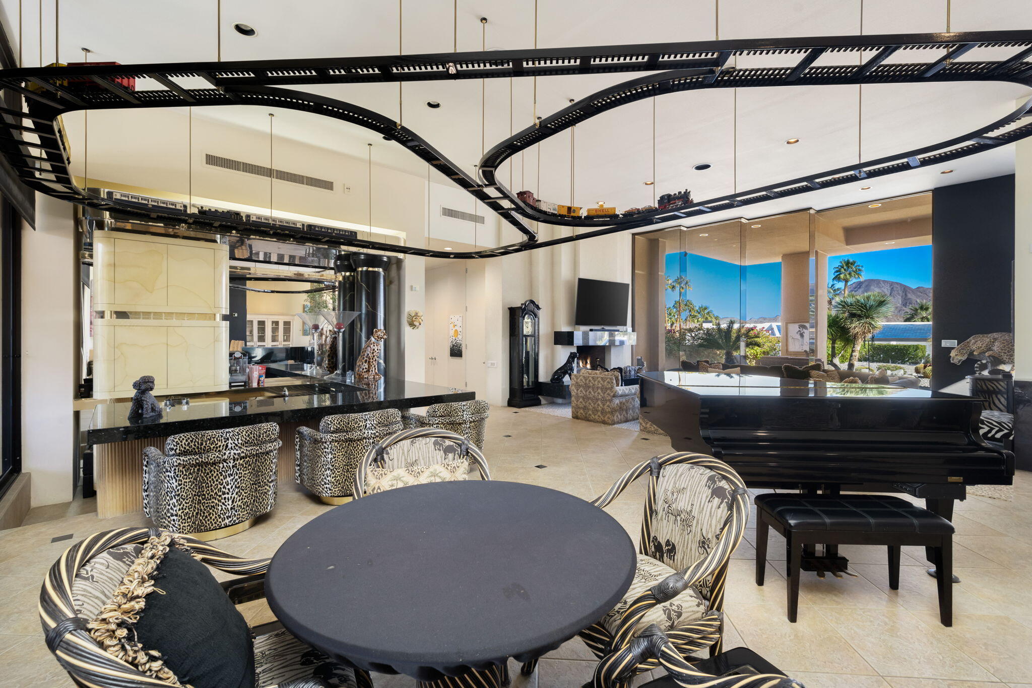 73380 Agave Lane Palm Desert, CA 92260 - Photo 14 of 81 a view of a dining room with furniture a chandelier and wooden floor