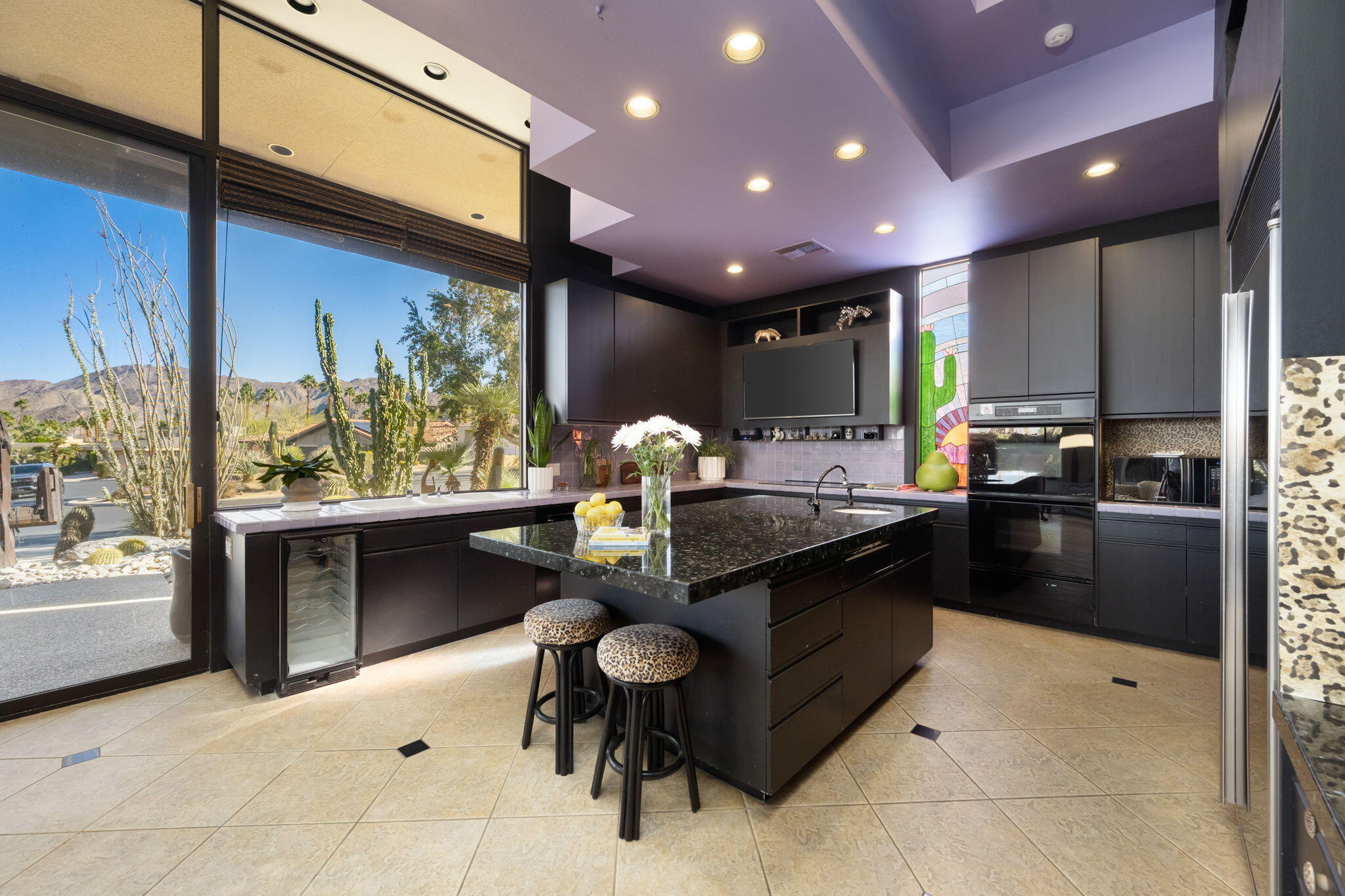 73380 Agave Lane Palm Desert, CA 92260 - Photo 25 of 81 a kitchen with stainless steel appliances kitchen island granite countertop a sink and cabinets