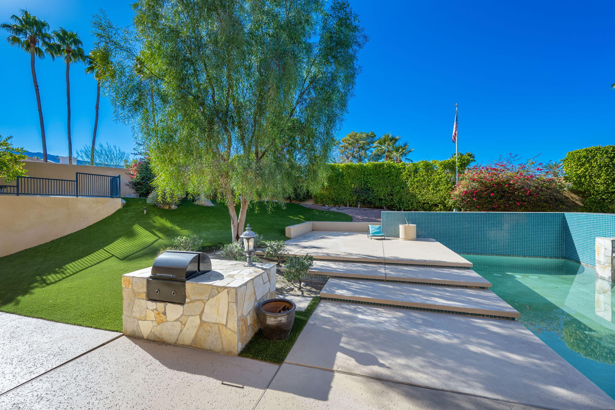 73380 Agave Lane Palm Desert, CA 92260 - Photo 48 of 81 a view of a patio with couches and a table and chairs with wooden fence