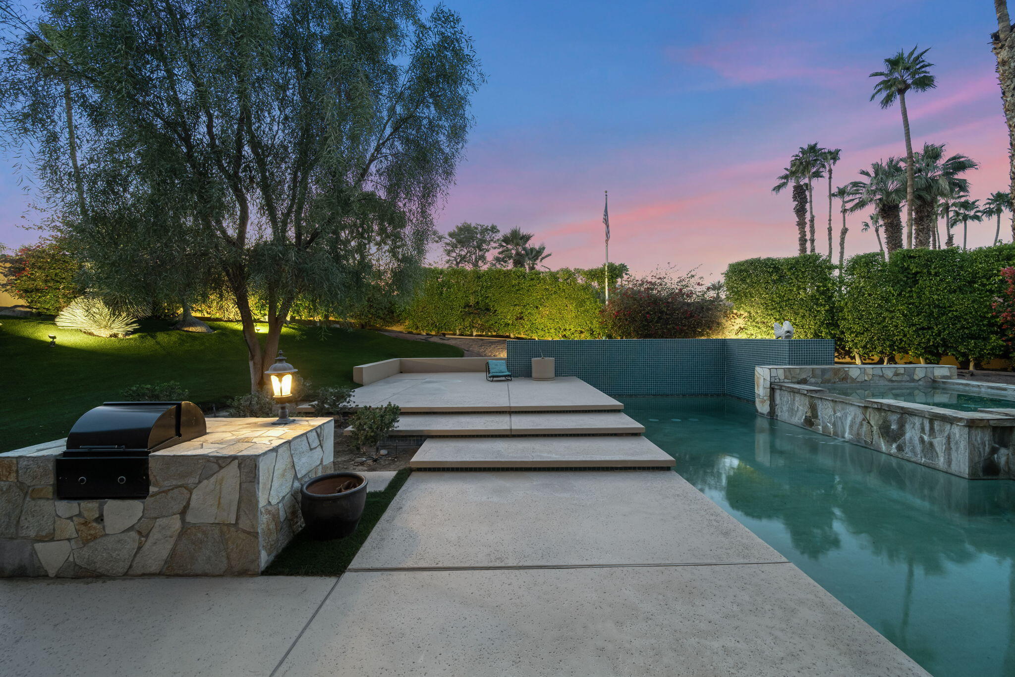 73380 Agave Lane Palm Desert, CA 92260 - Photo 58 of 81 a view of a patio with table and chairs potted plants and a palm tree