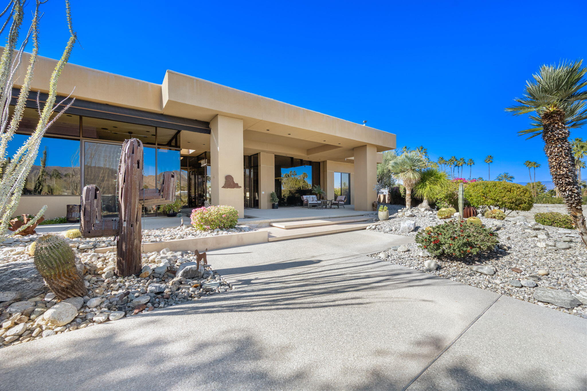 73380 Agave Lane Palm Desert, CA 92260 - Photo 63 of 81 a view of a house with potted plants and a large tree