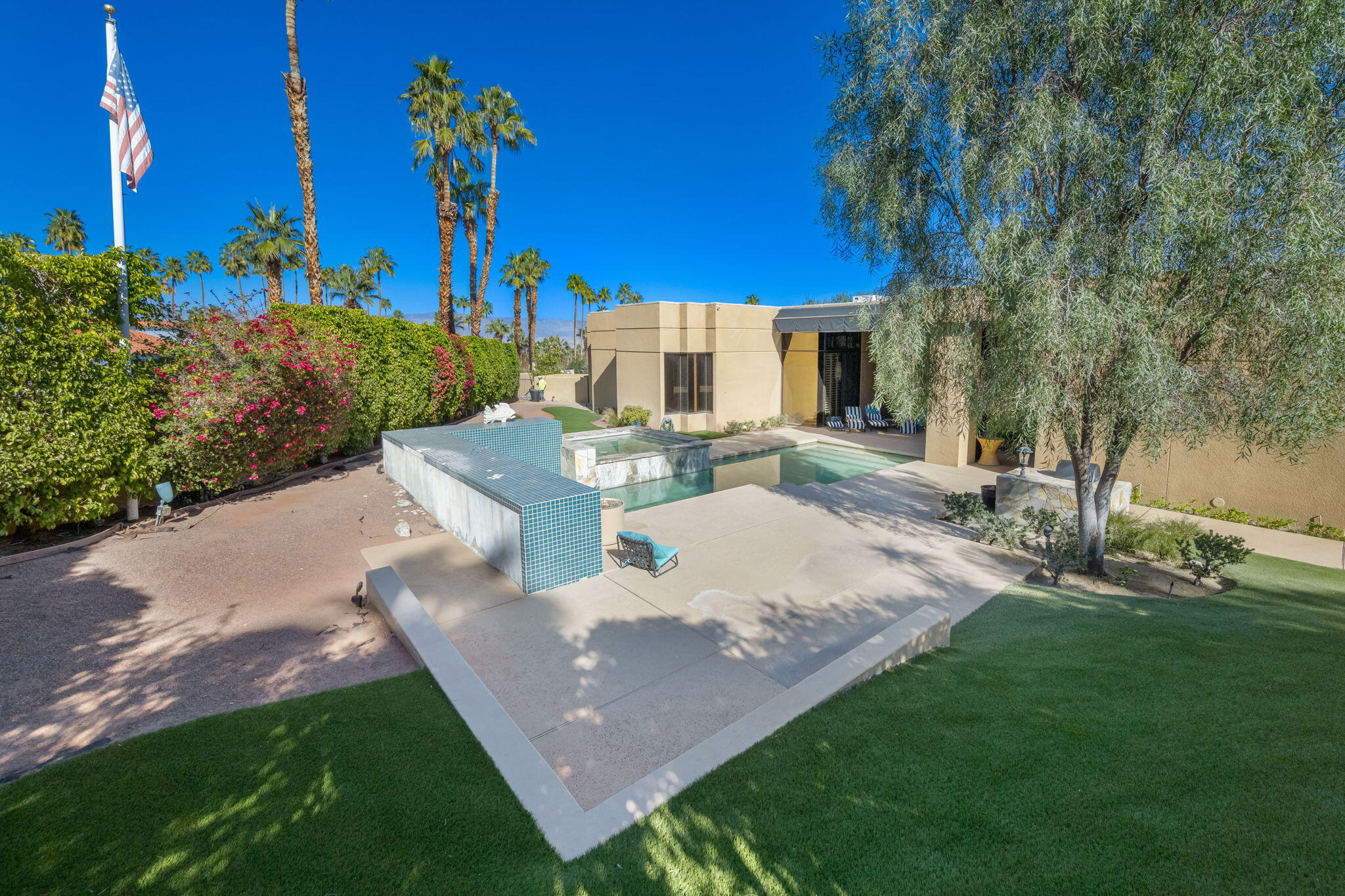 73380 Agave Lane Palm Desert, CA 92260 - Photo 74 of 81 a view of a patio with table and chairs and potted plants