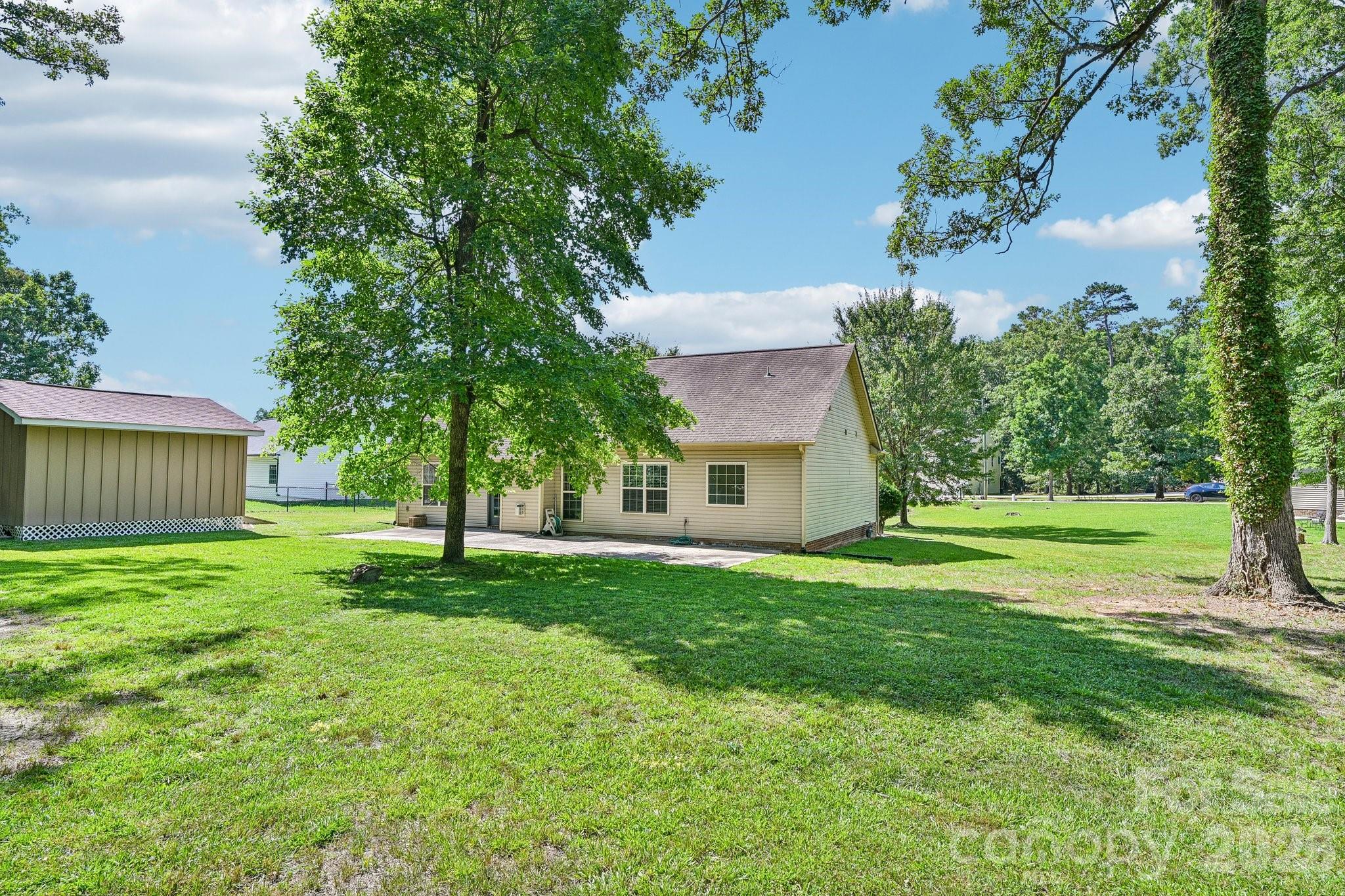 624 Hunley Street Monroe, NC 28112 - Photo 31 of 36 a view of a house with a big yard and palm trees