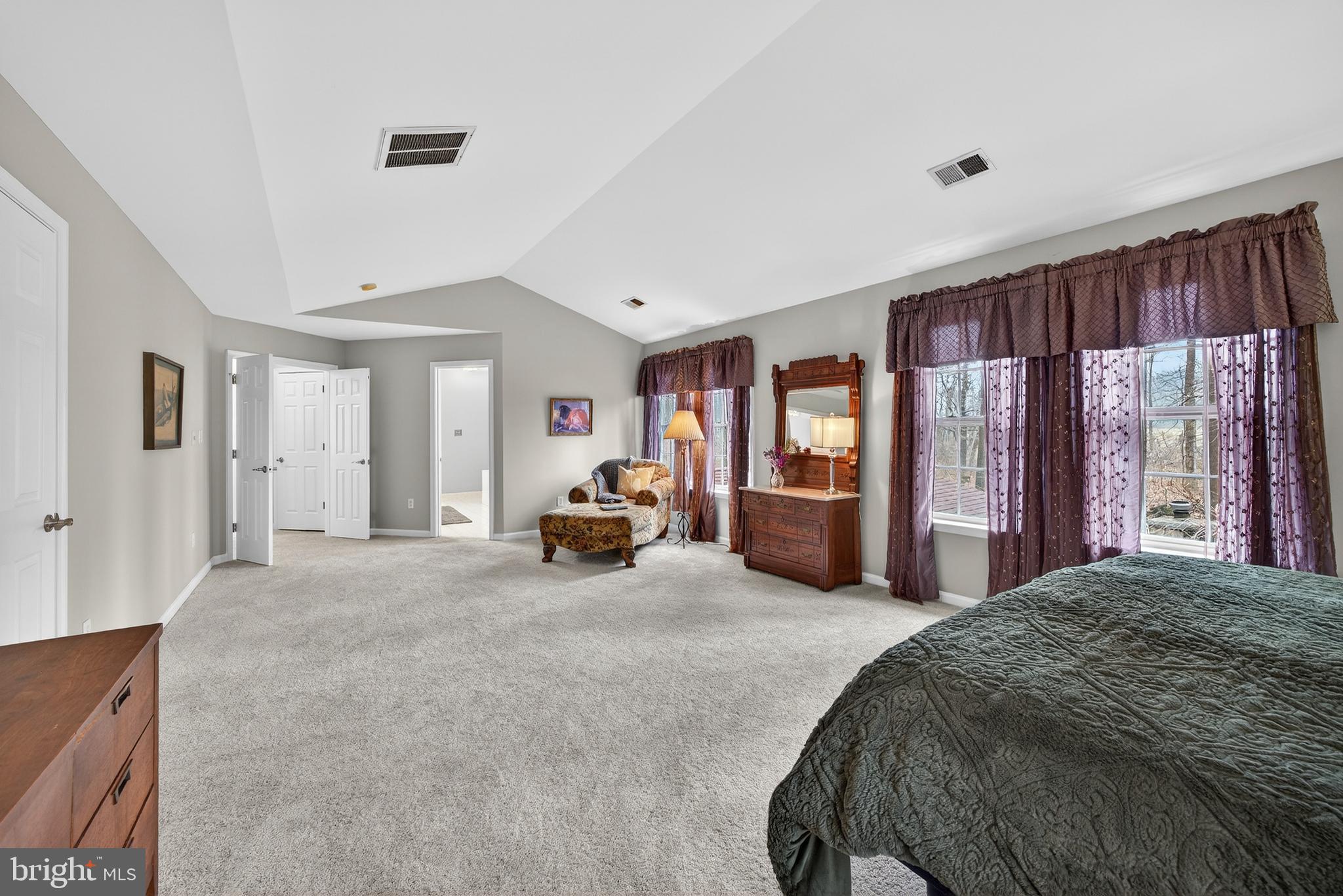 5777 White Rock Road Sykesville, MD 21784 - Photo 24 of 42 a spacious bedroom with a bed a table and large windows