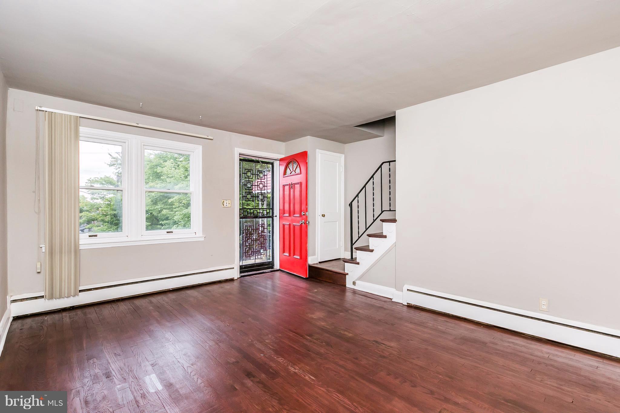 4016 Rexmere Road Baltimore, MD 21218 - Photo 2 of 26 an empty room with wooden floor and windows